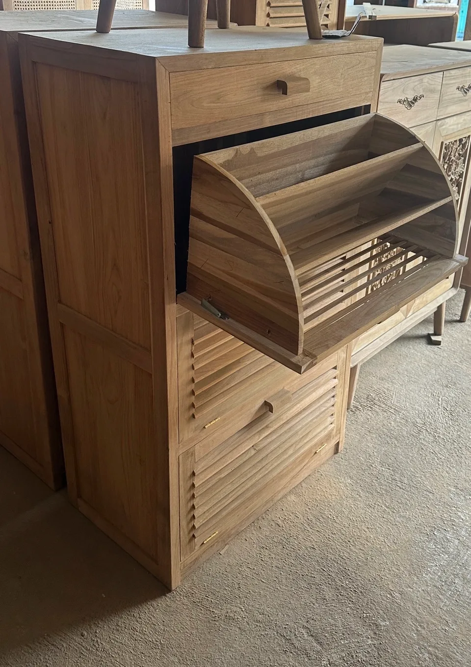 Shoe cabinet with a louvered compartment tilted open